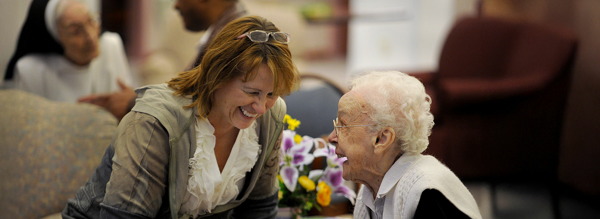 woman speaking with elderly woman