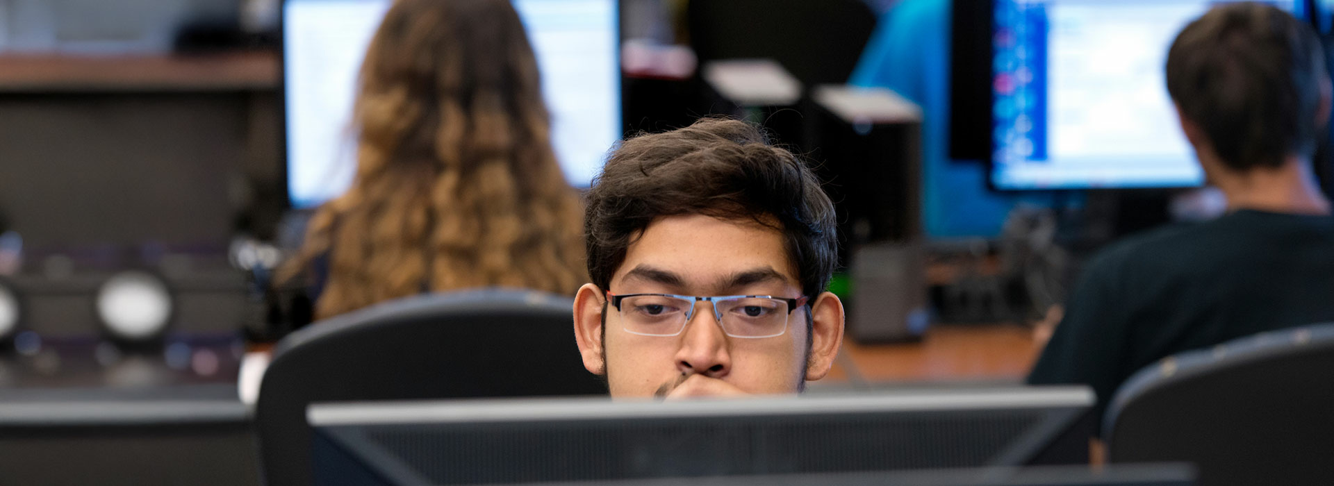 student behind computer screen