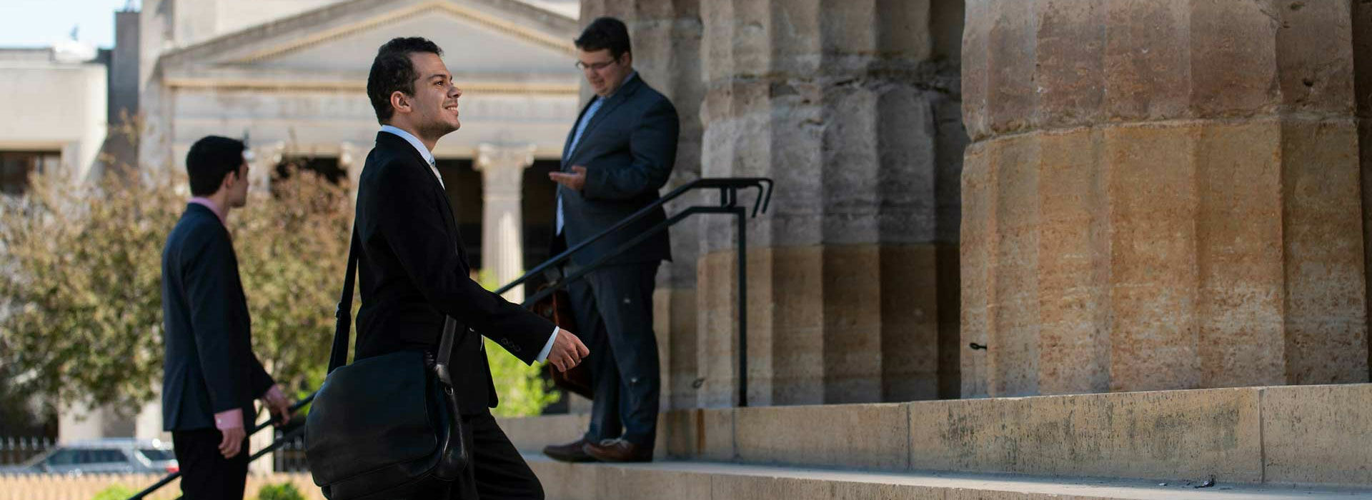 male lawmaker climbing steps of Capitol with a smile on his face