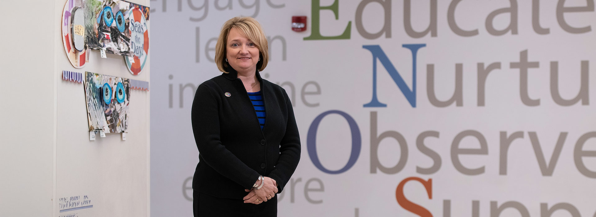 teacher in front of word wall