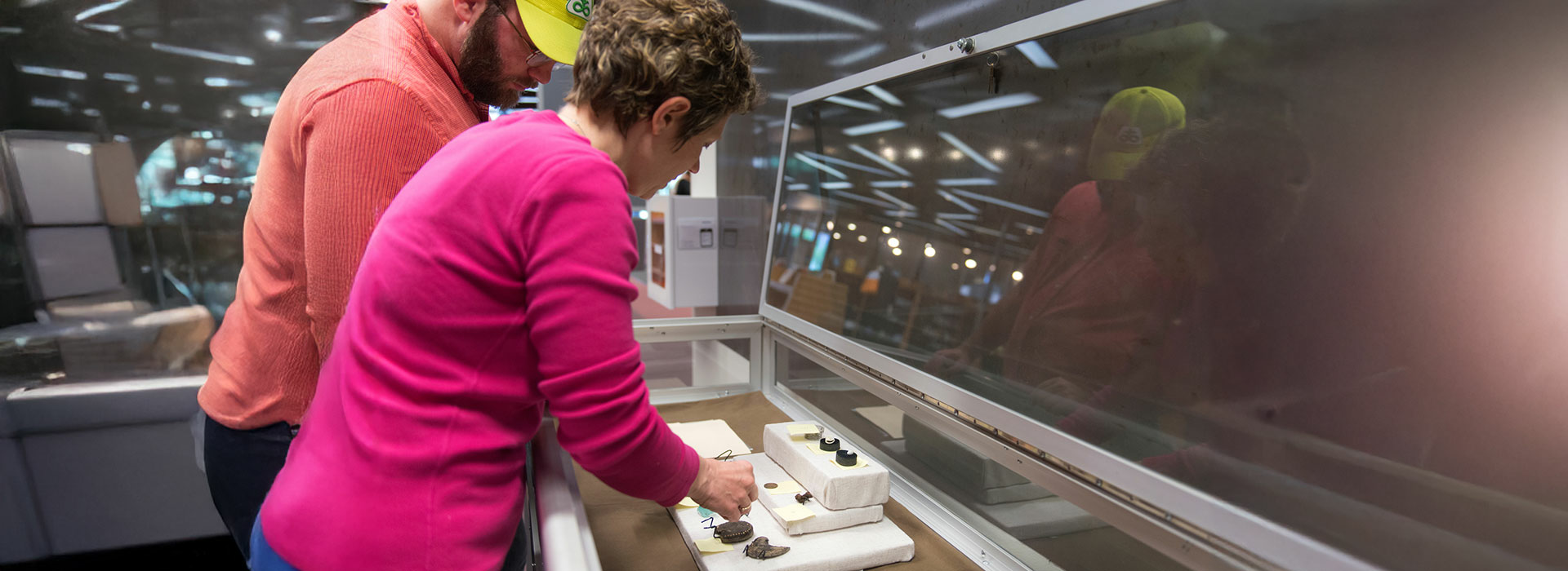 professor looking at artifacts