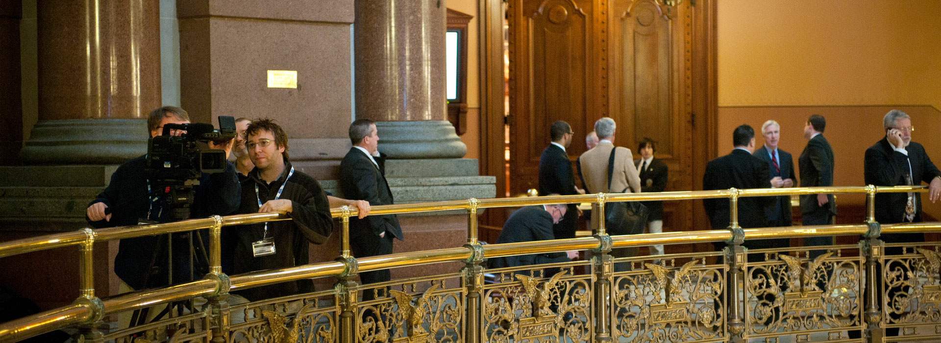 several people at the railing of the second floor of the Illinois Capitol Building