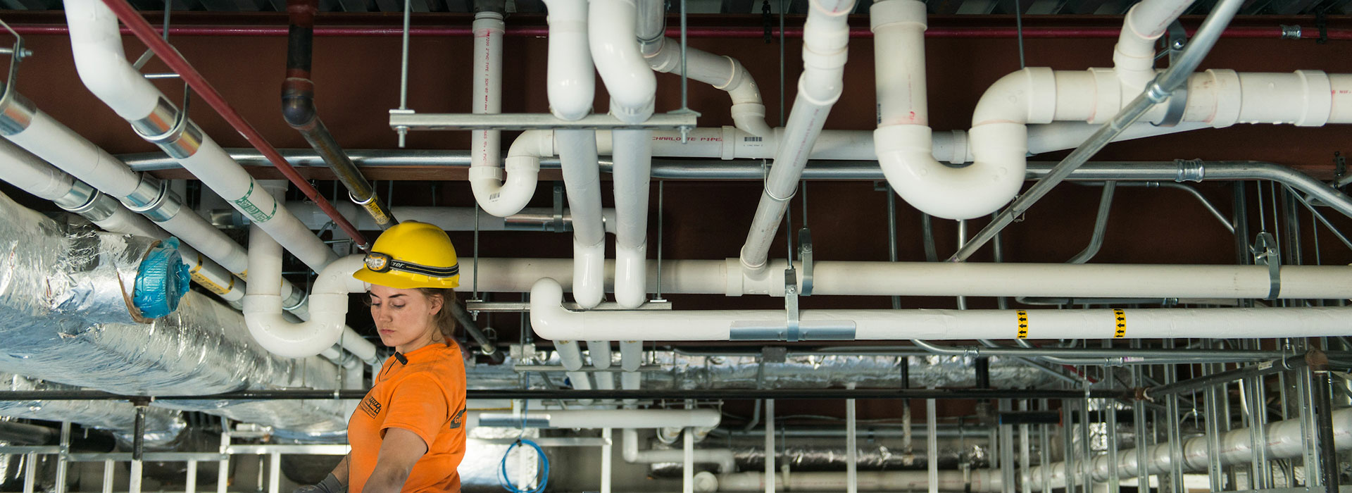 student looking at pipes