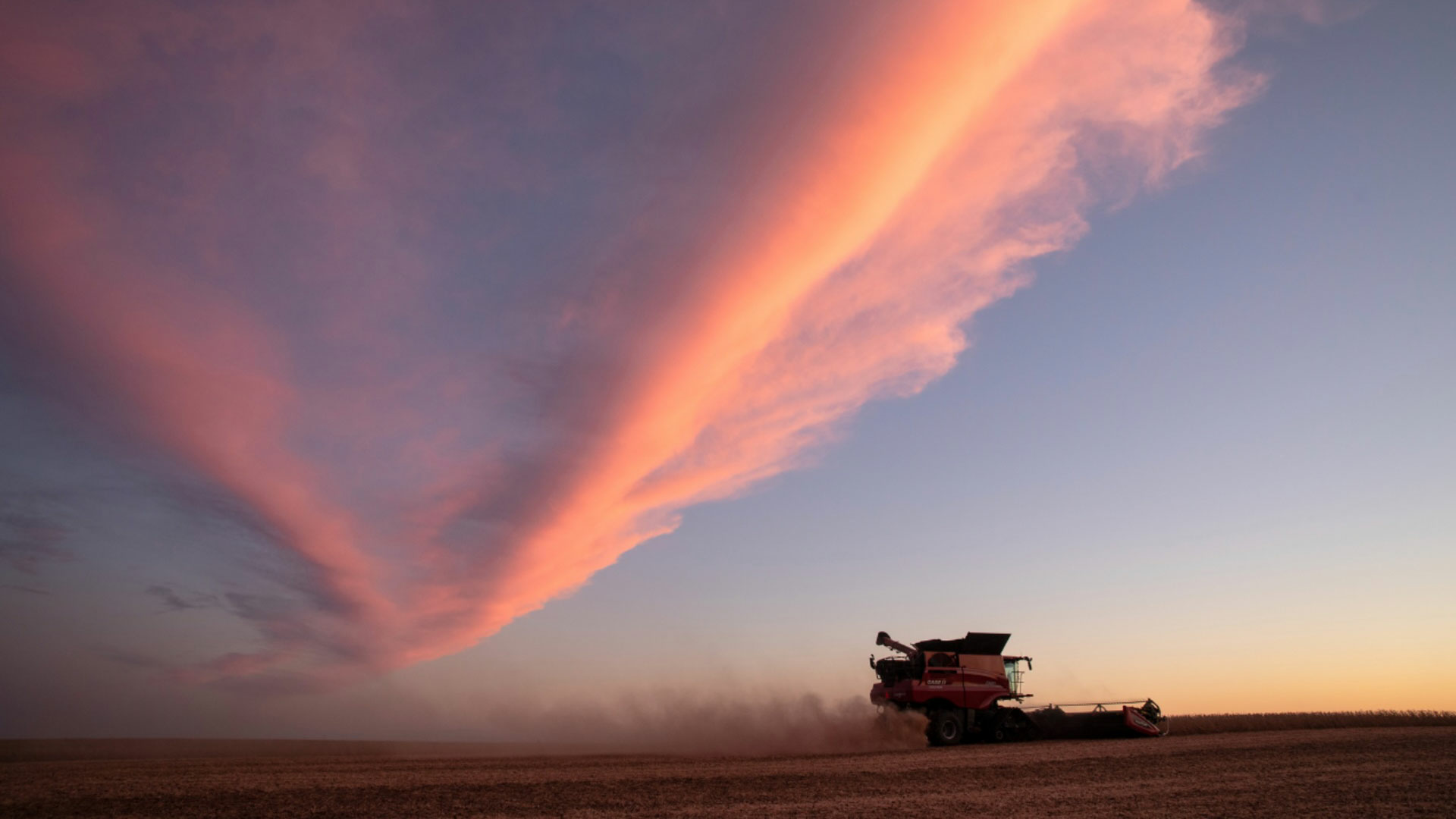 Combine traveling through a field