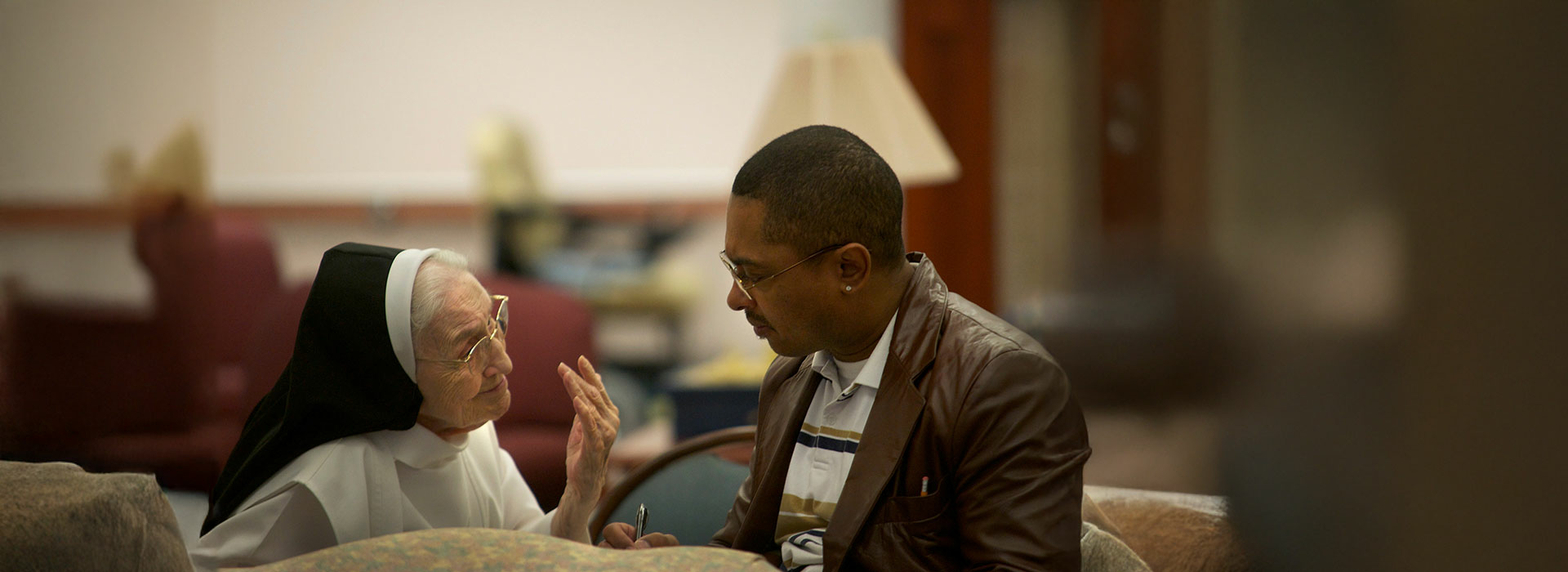 student talking to older nun