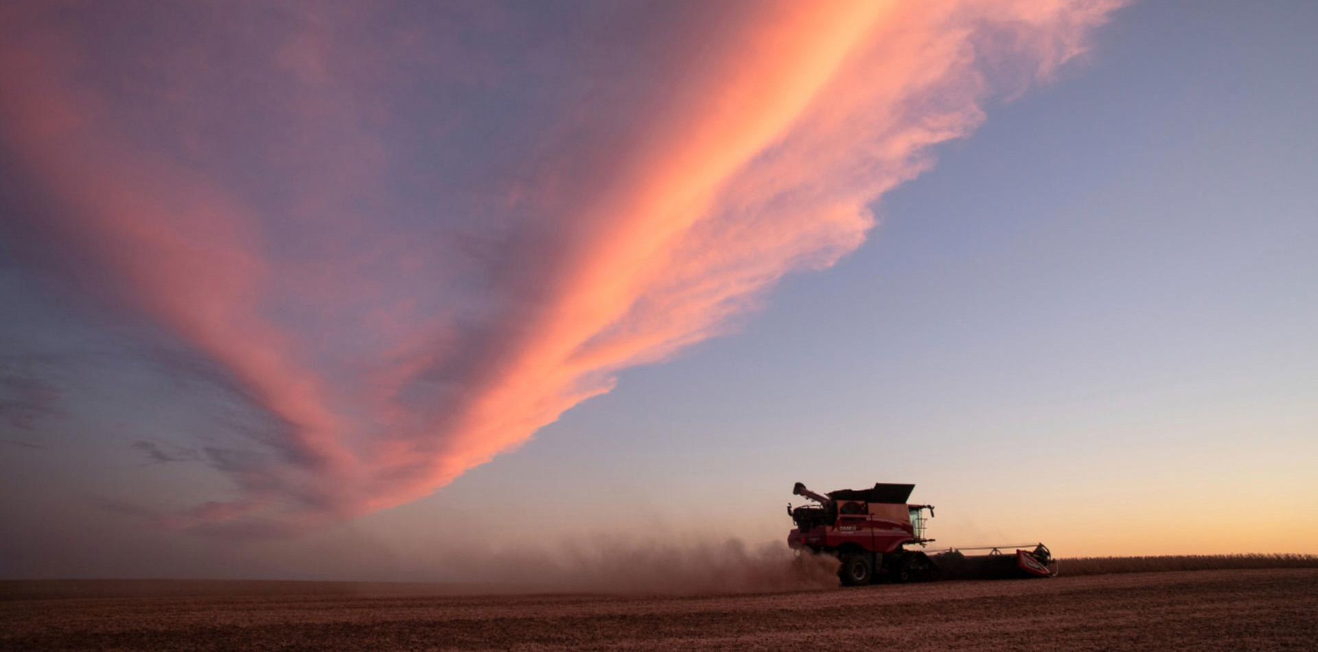 Combine traveling through a field