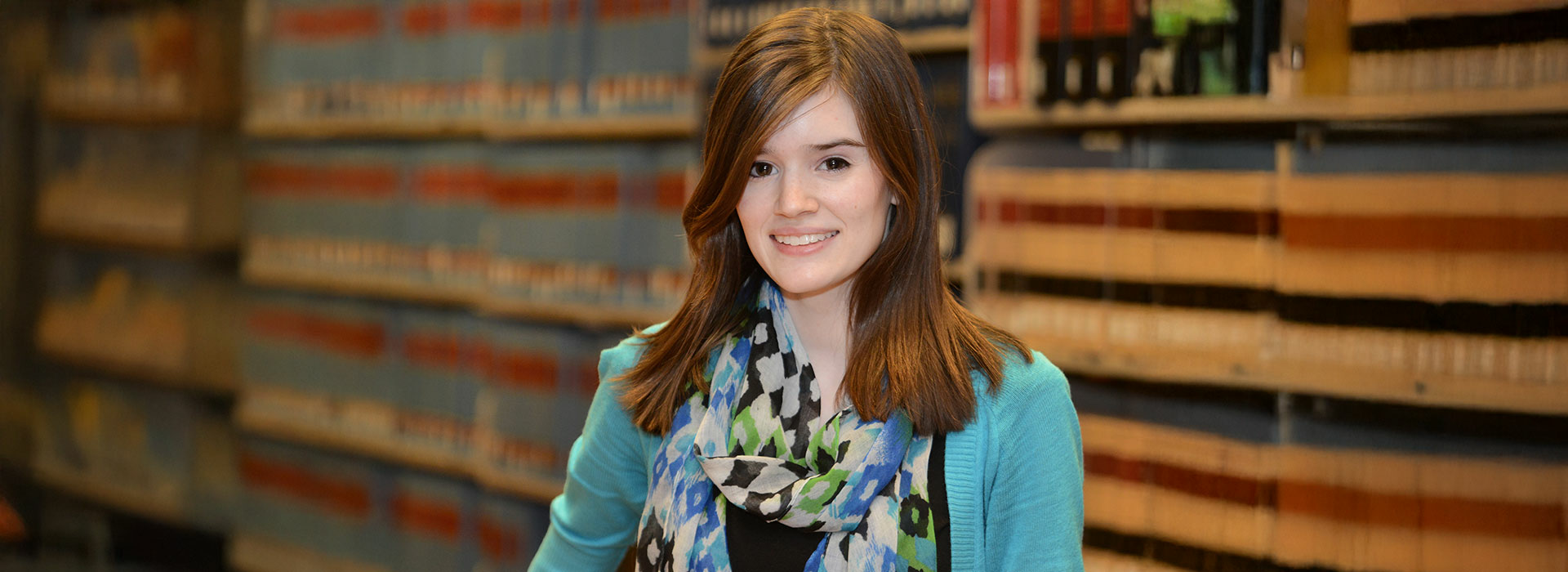 student in front of law books