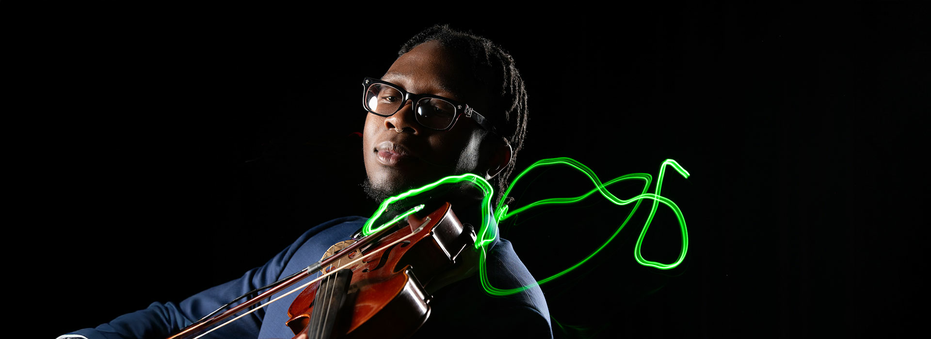 student playing violin with neon bow