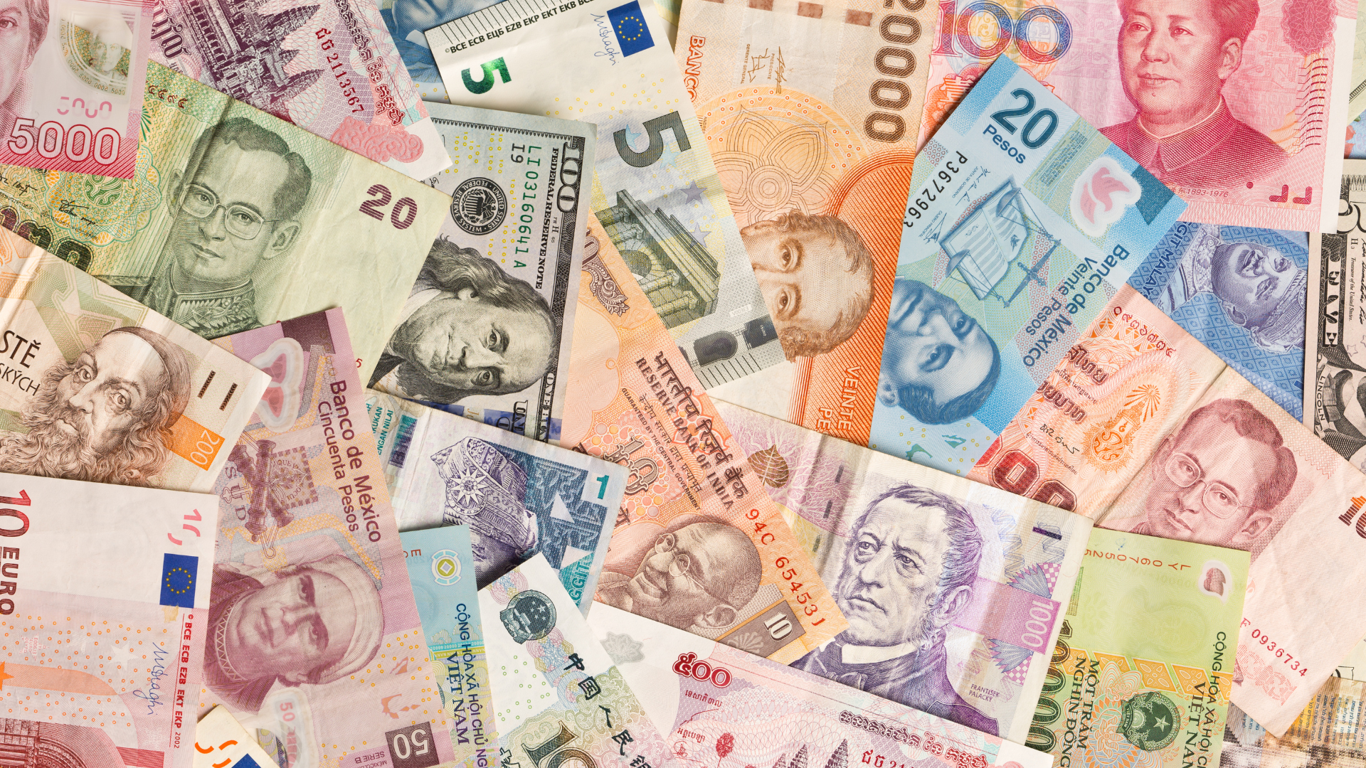 A collection of foreign currency that is spread out in a disorganized matter.