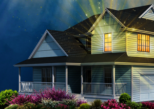 a blue suburban house with a light shining brightly out of one of its windows